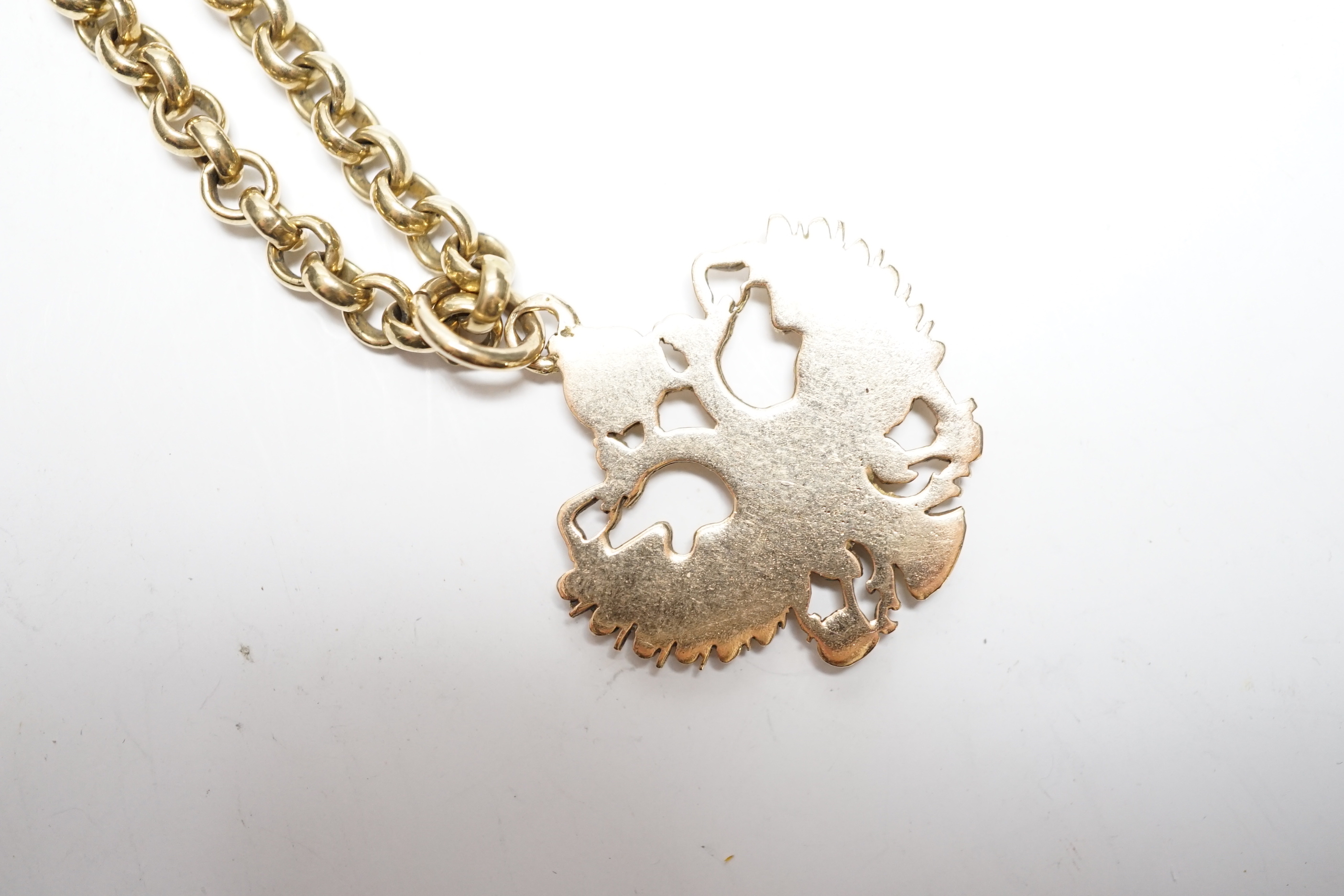 An Austrian yellow metal double eagle pendant, width 31mm, on a 9ct gold belcher link chain, 62cm, gross weight 52.1 grams.